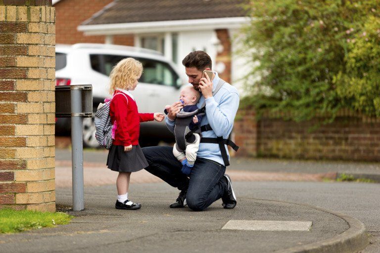 child next to a man holding a baby