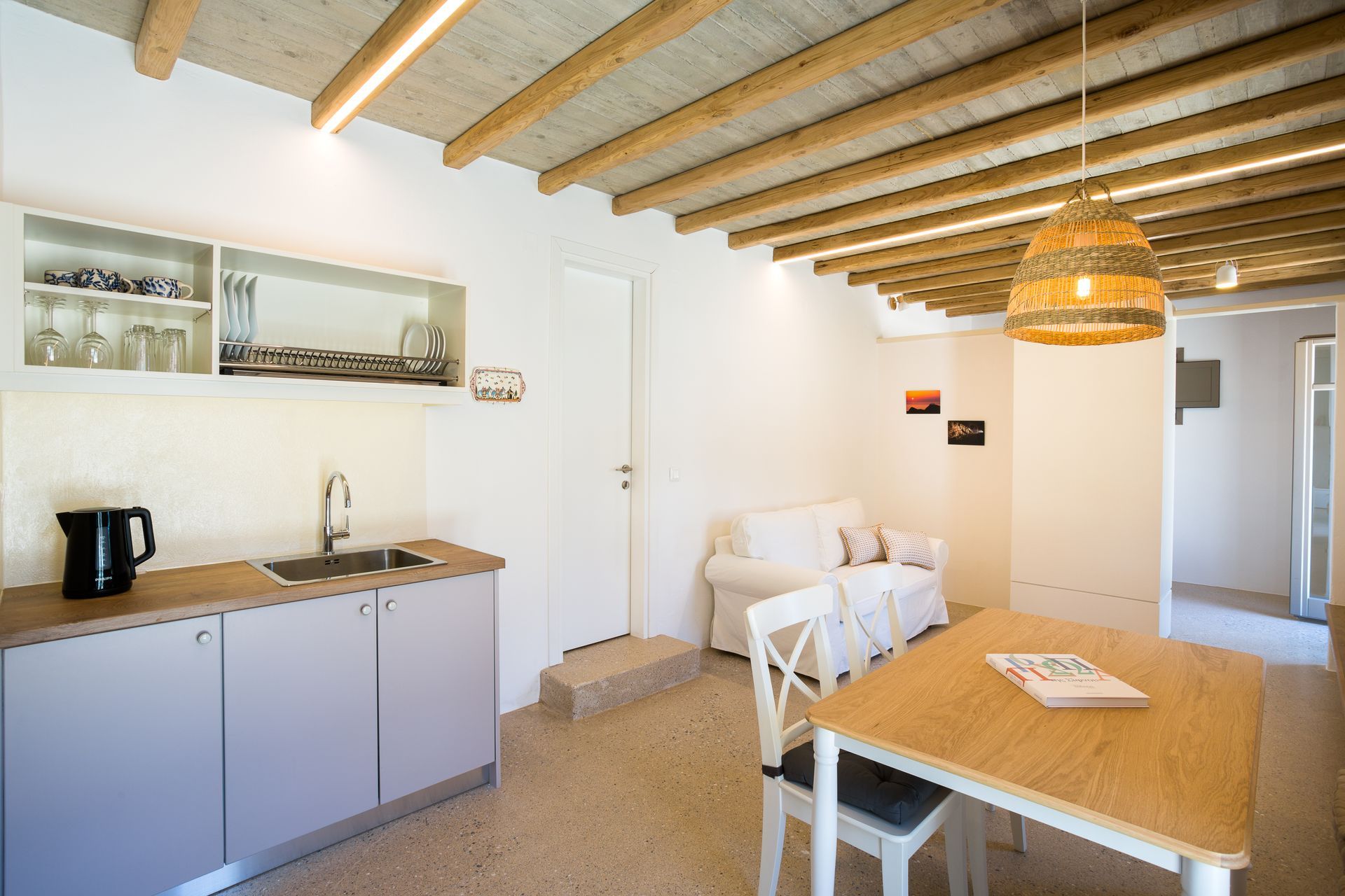 A kitchen with a table and chairs and a couch.