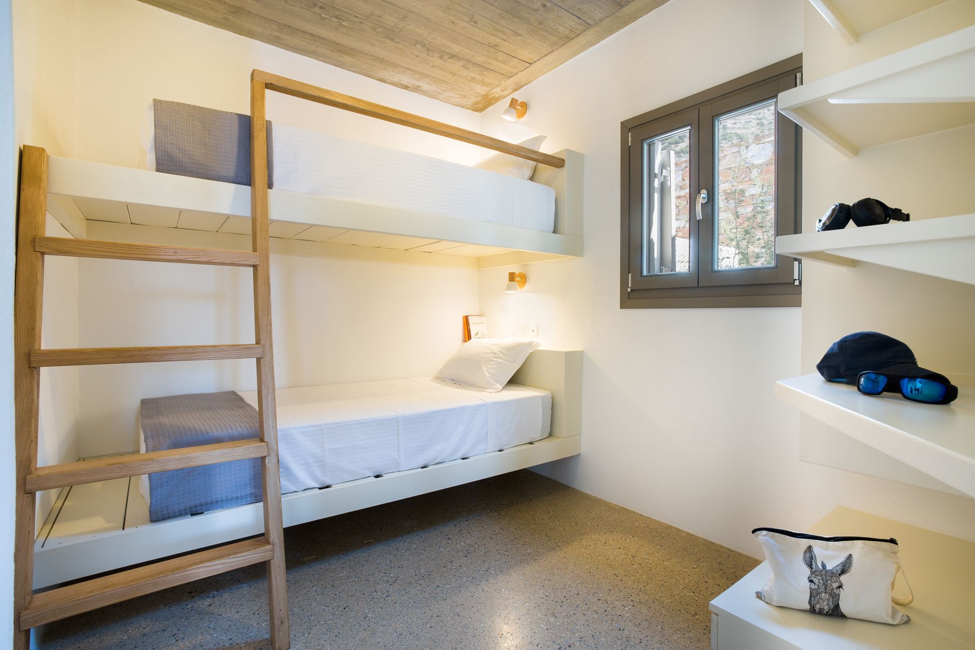 A bedroom with two bunk beds and a window.