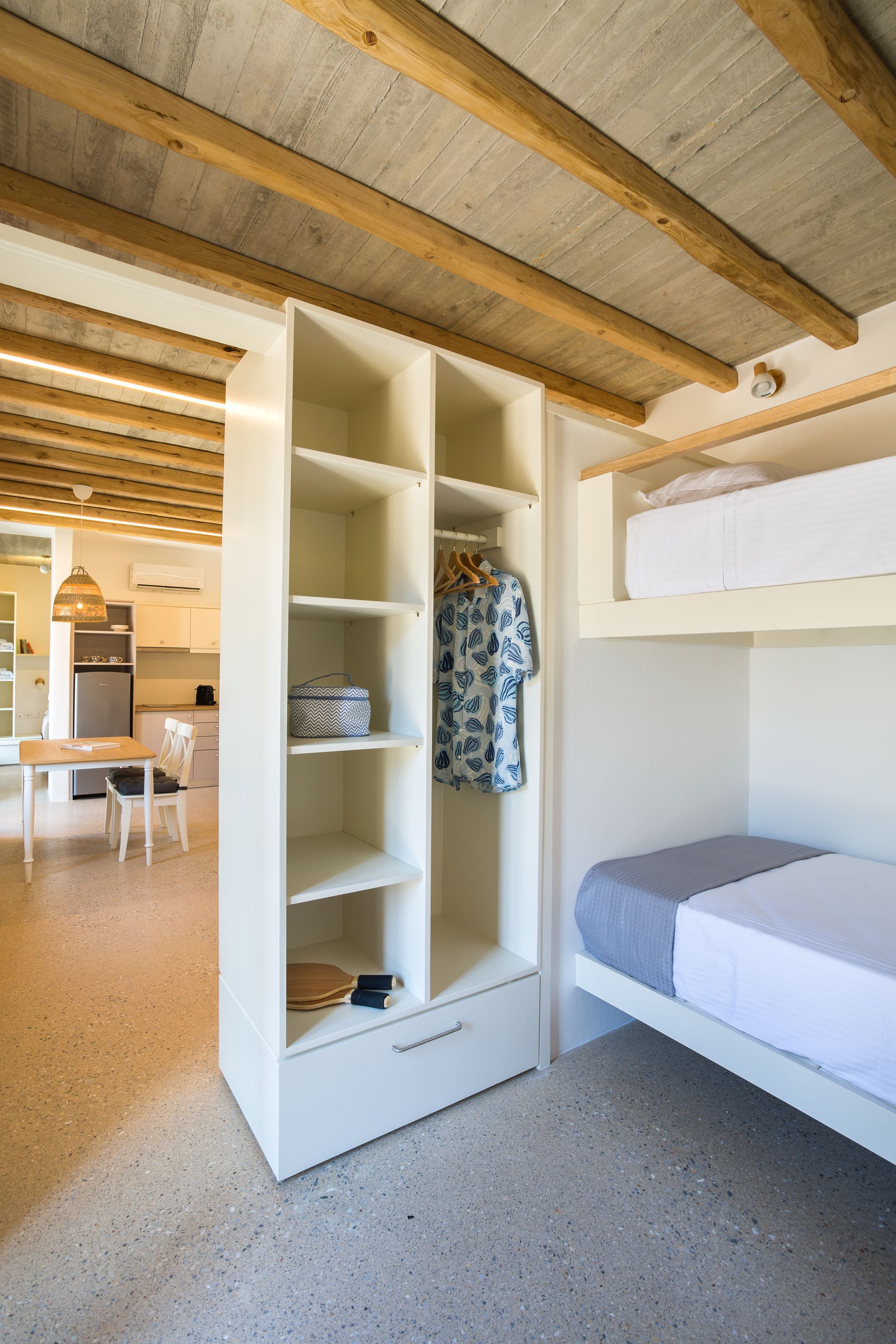 A bedroom with a bunk bed and a closet.