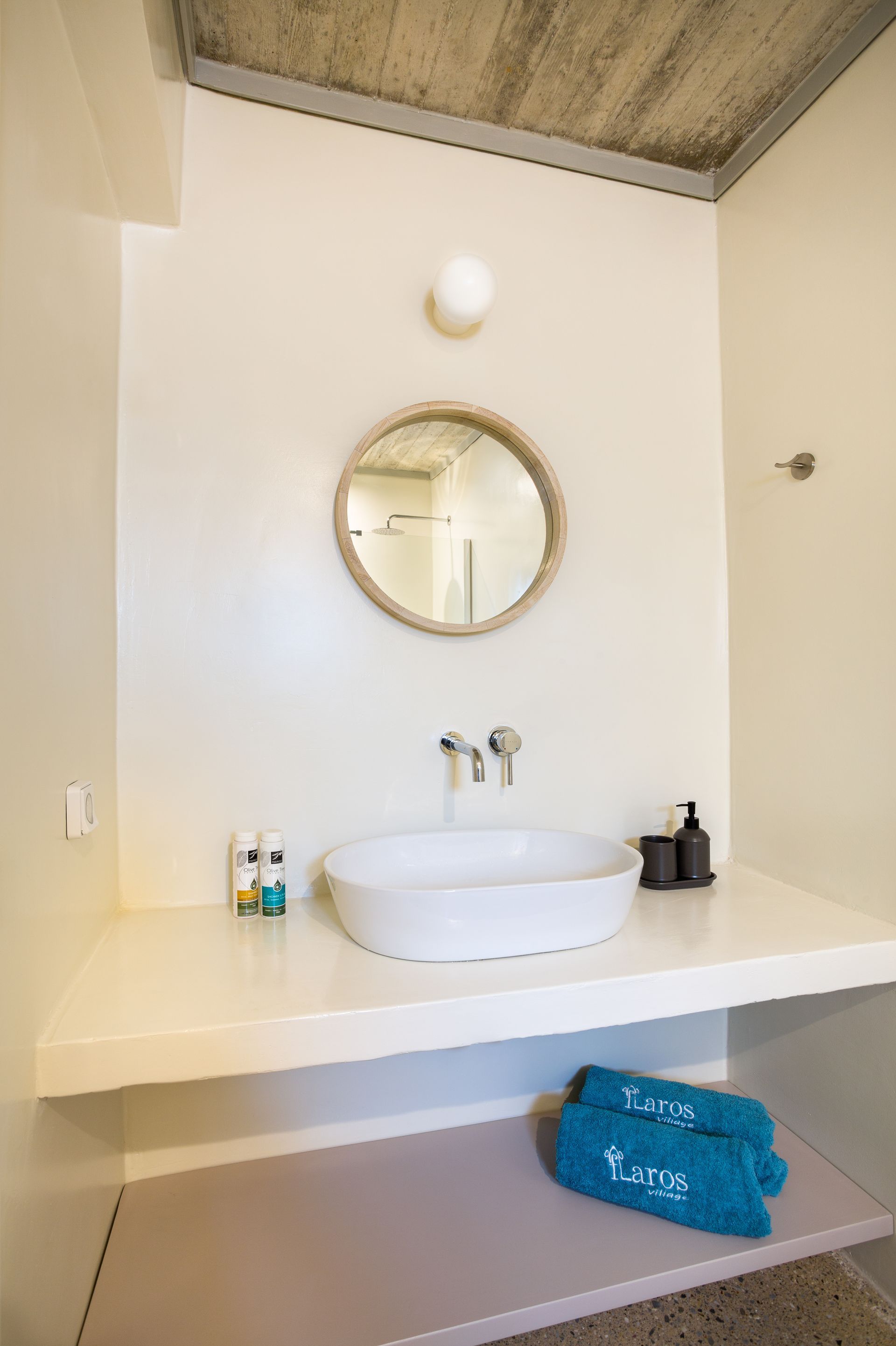 A bathroom with a sink and a mirror on the wall.