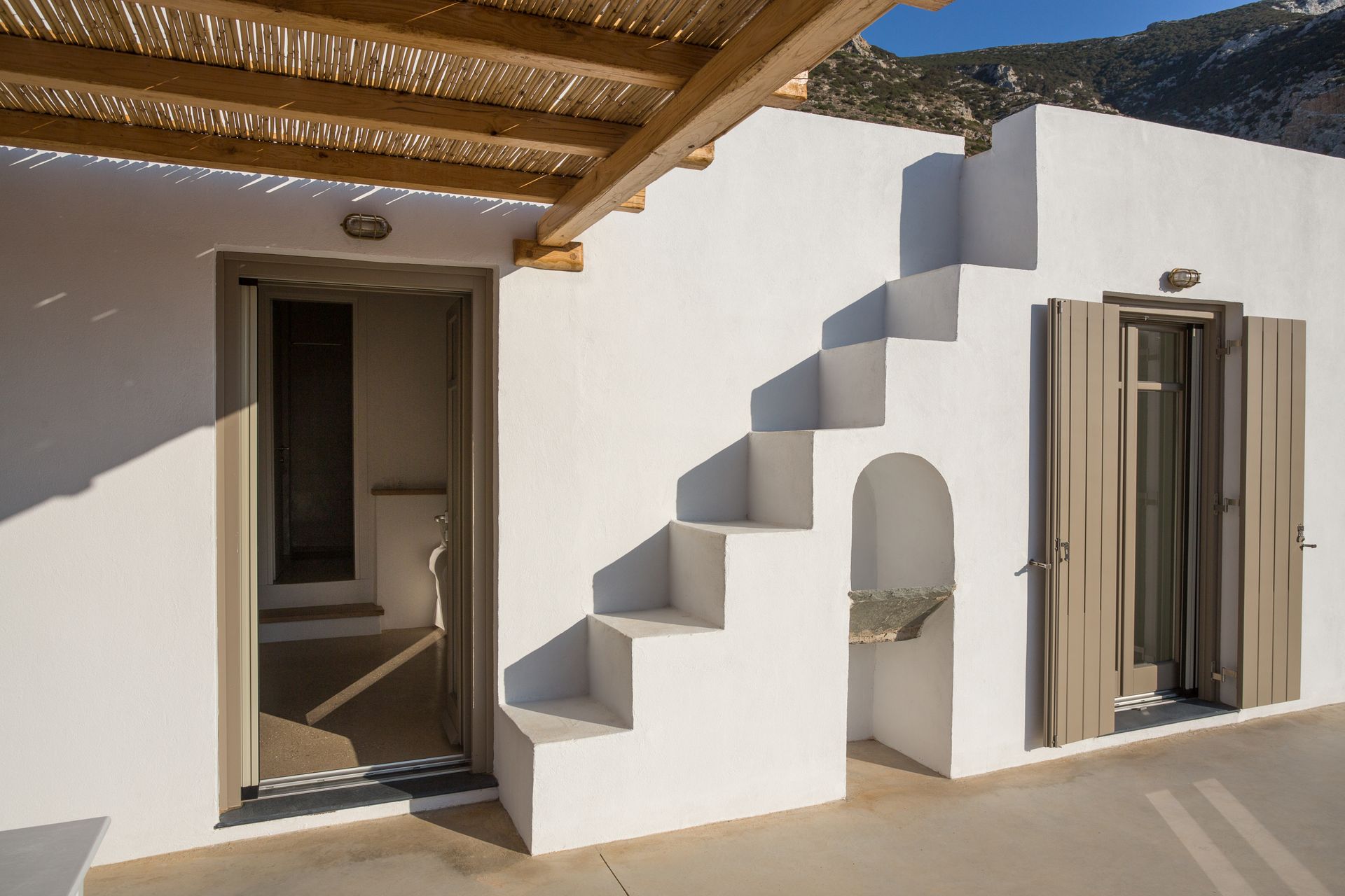 A white building with stairs leading up to it