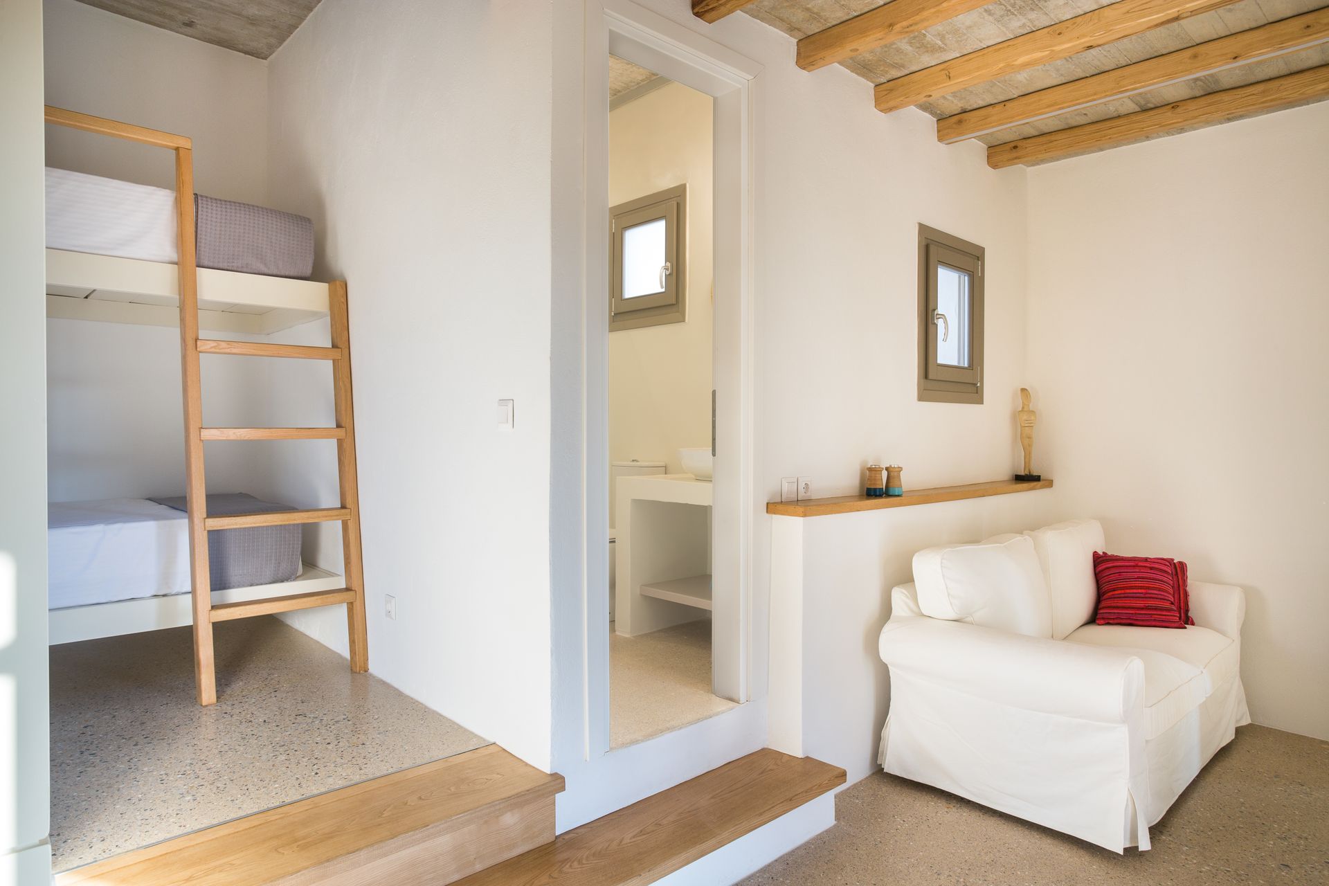 A living room with a bunk bed and a couch