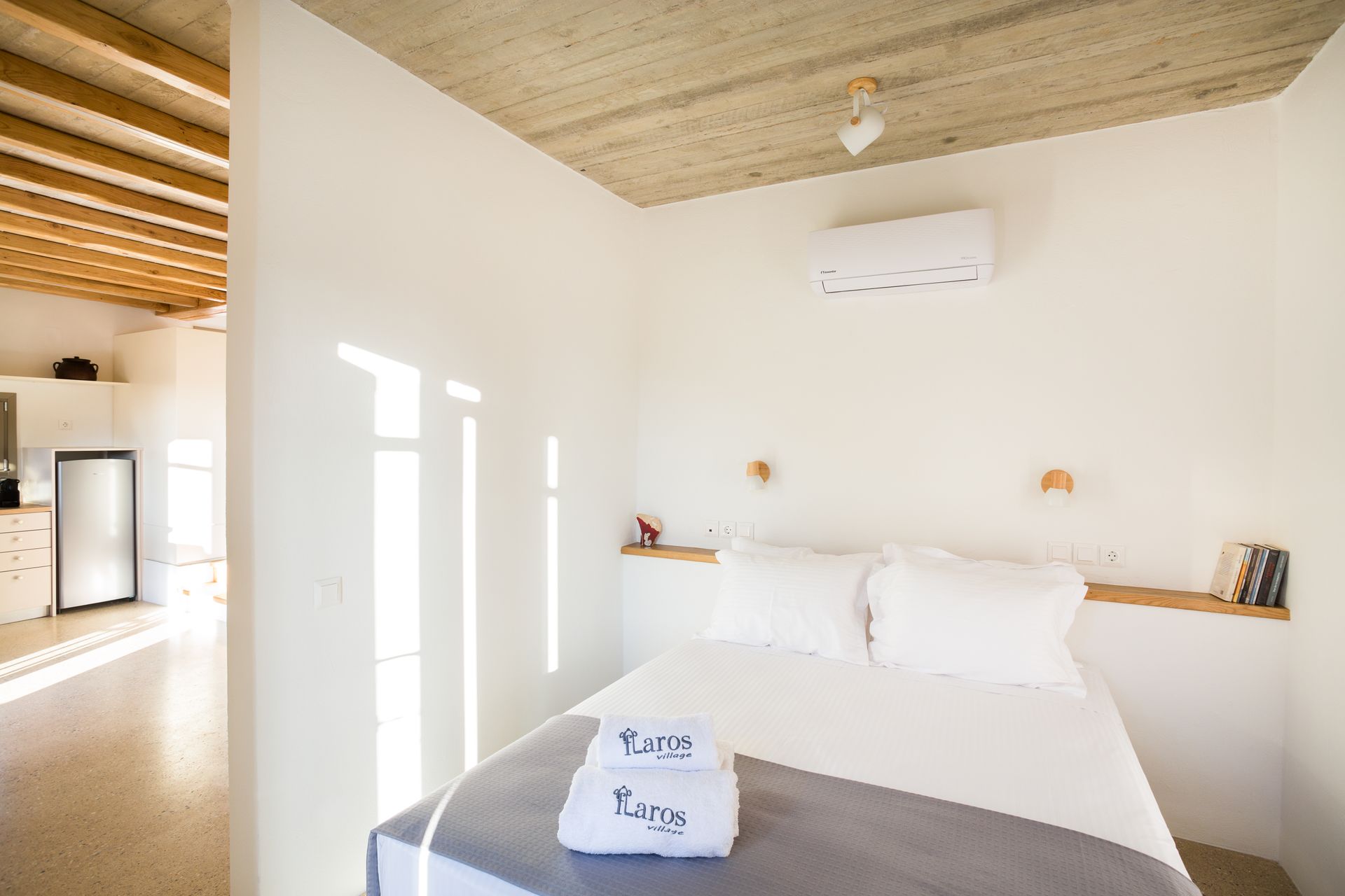 A bedroom with a bed and two towels on the bed.
