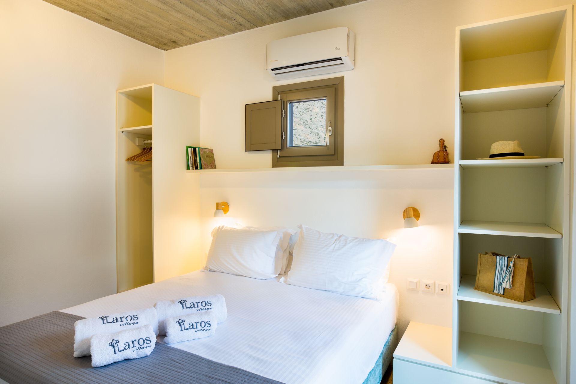 A bedroom with a bed , shelves , and a window.