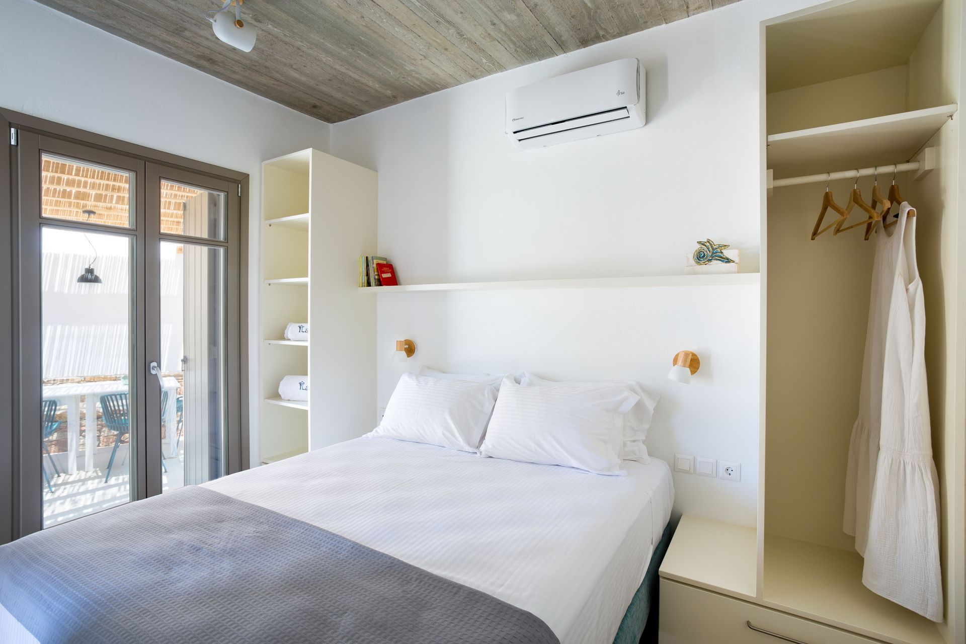 A bedroom with a large bed and a closet.