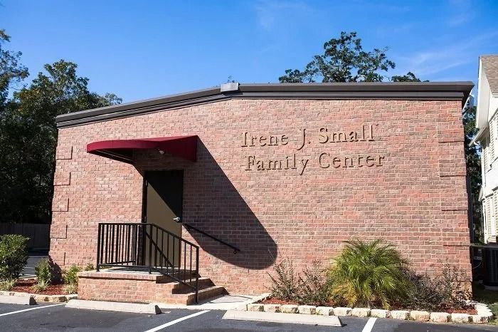 The Irene J. Small Family Center is a one-story brick building with a maroon awning over the entrance door.