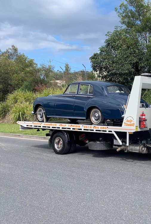 Tow Truck Carrying a Dark Blue Classic Car on a Flatbed — Coffs Harbour Help Towing in Coffs Harbour, NSW