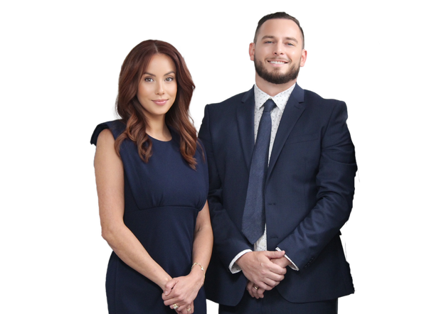 A man and a woman in suits and ties are standing next to each other.