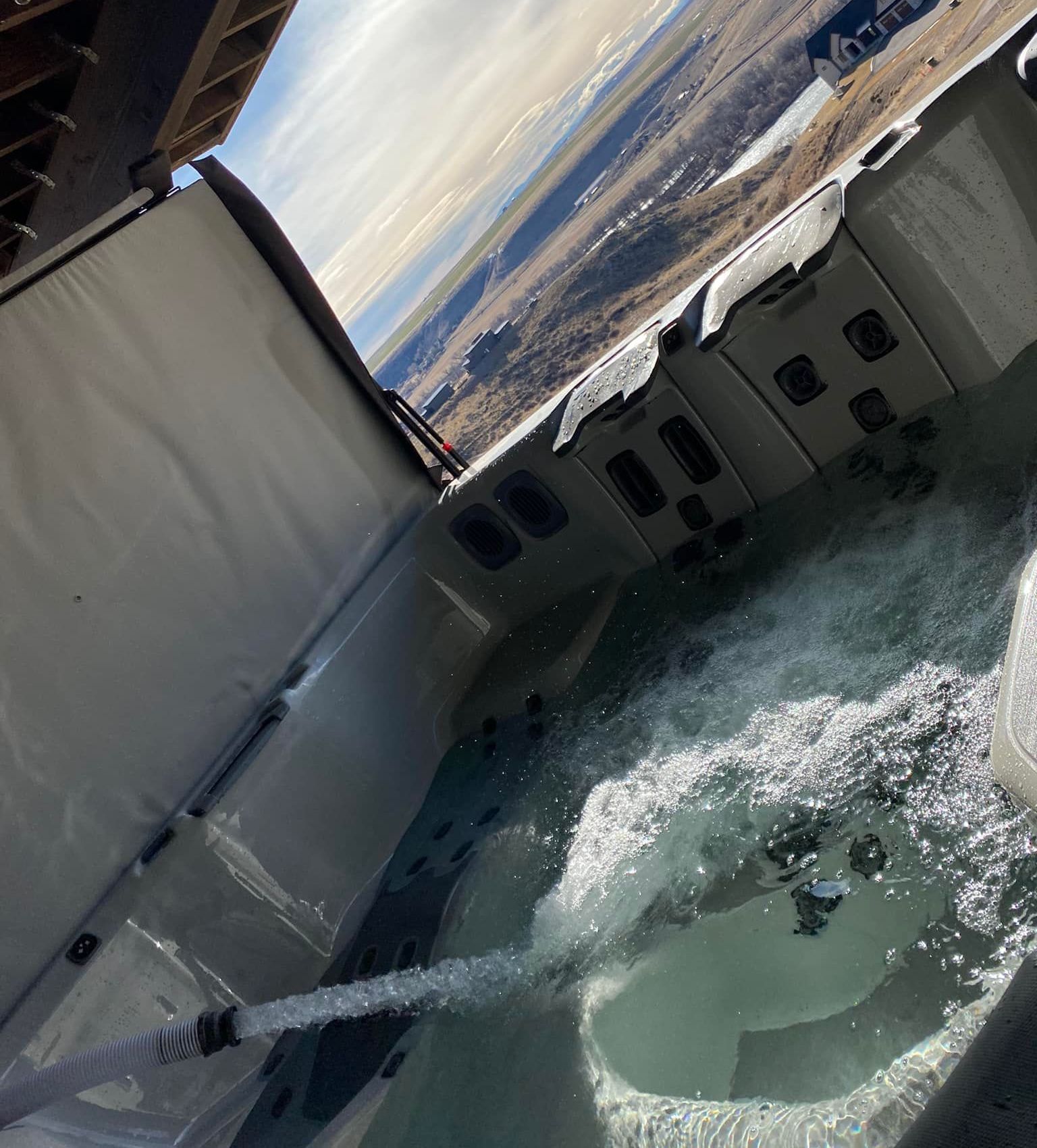 A hot tub with a hose coming out of it