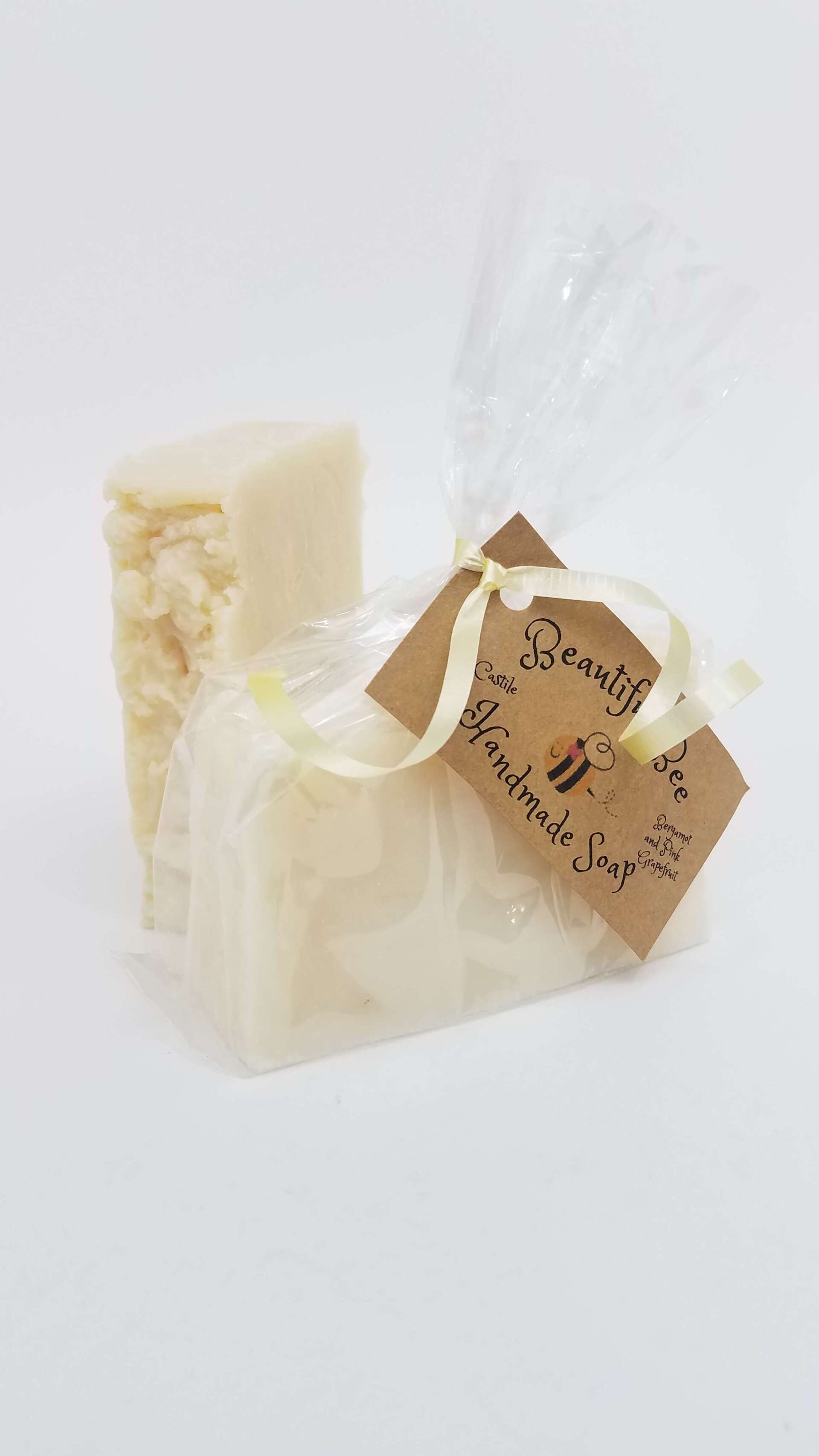 A piece of soap is wrapped in plastic and has a tag attached to it.