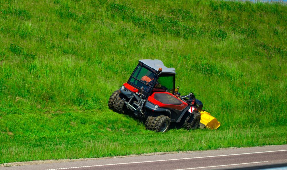 Red And Black Tractor Mowing — Northern Rivers Acreage Mowing in Ballina, NSW