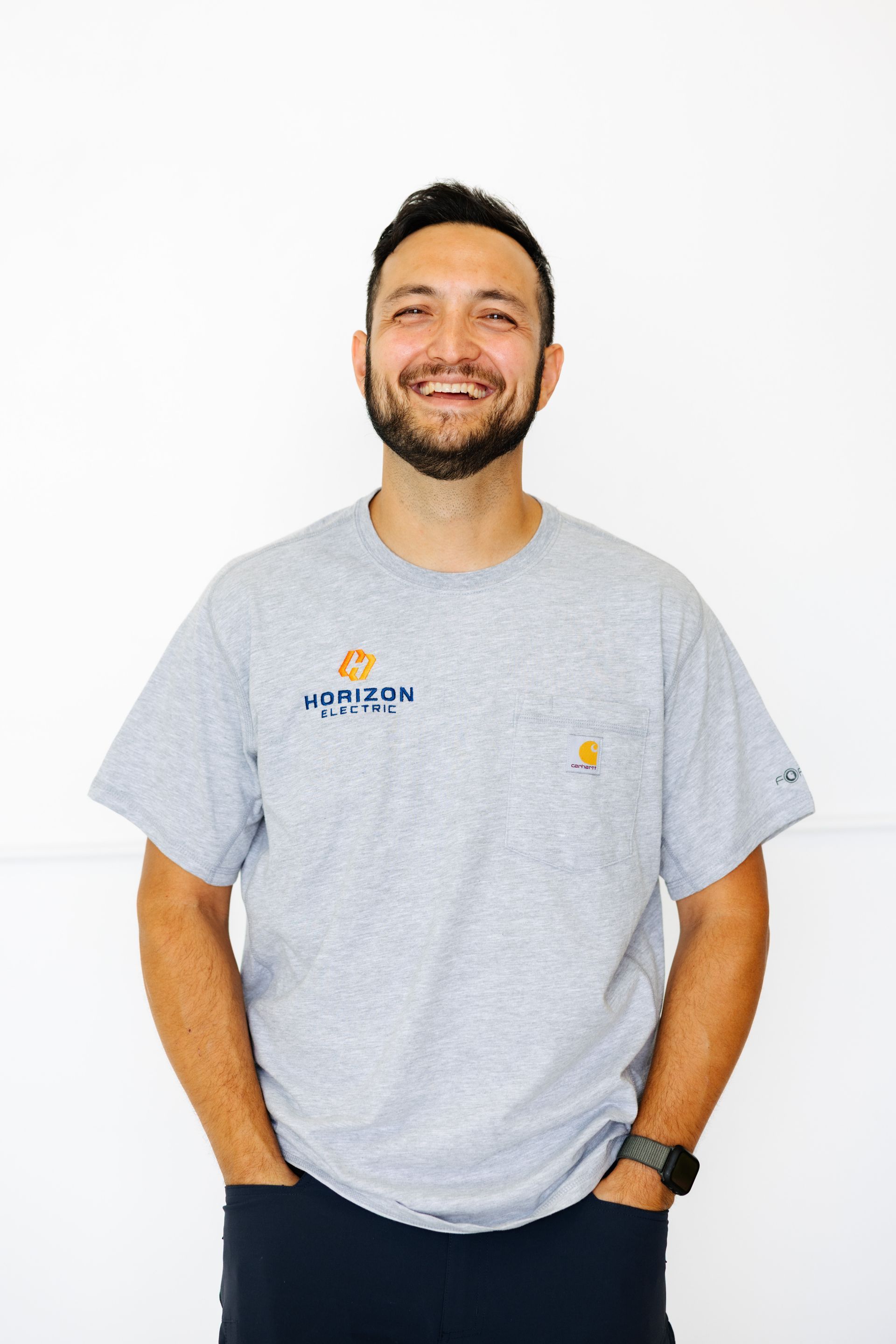 A person in a blue work shirt and cap with a