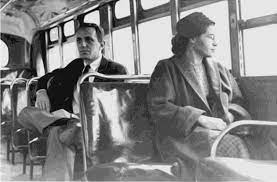 A man and a woman are sitting on a bus.