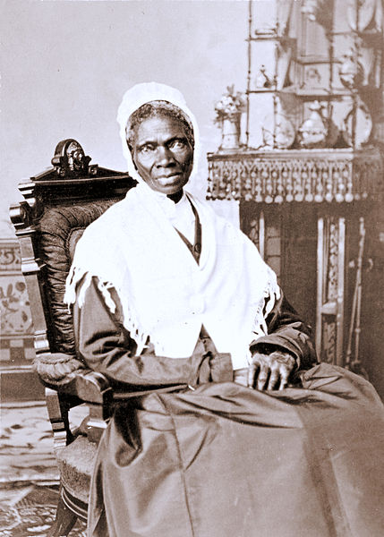 a black and white photo of a woman sitting in a chair