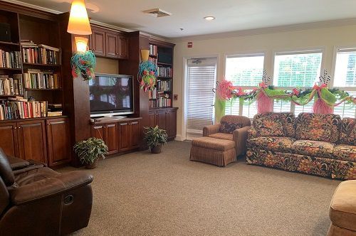 A living room with a couch , chairs and a fireplace