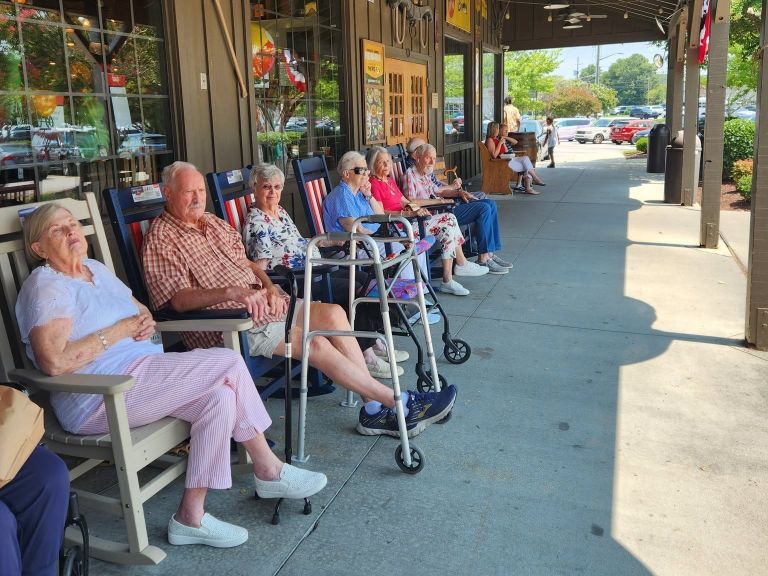 A restaurant visit of people sitting outside  with our senior living community near Raleigh, NC.