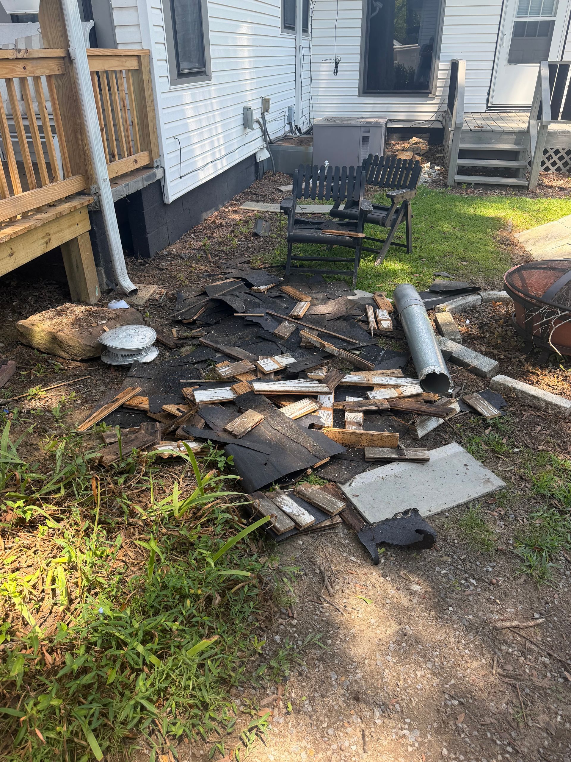 a house with a lot of trash in front of it .