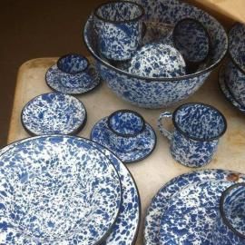 Blue-and-white speckled china dinnerware set arranged on a table