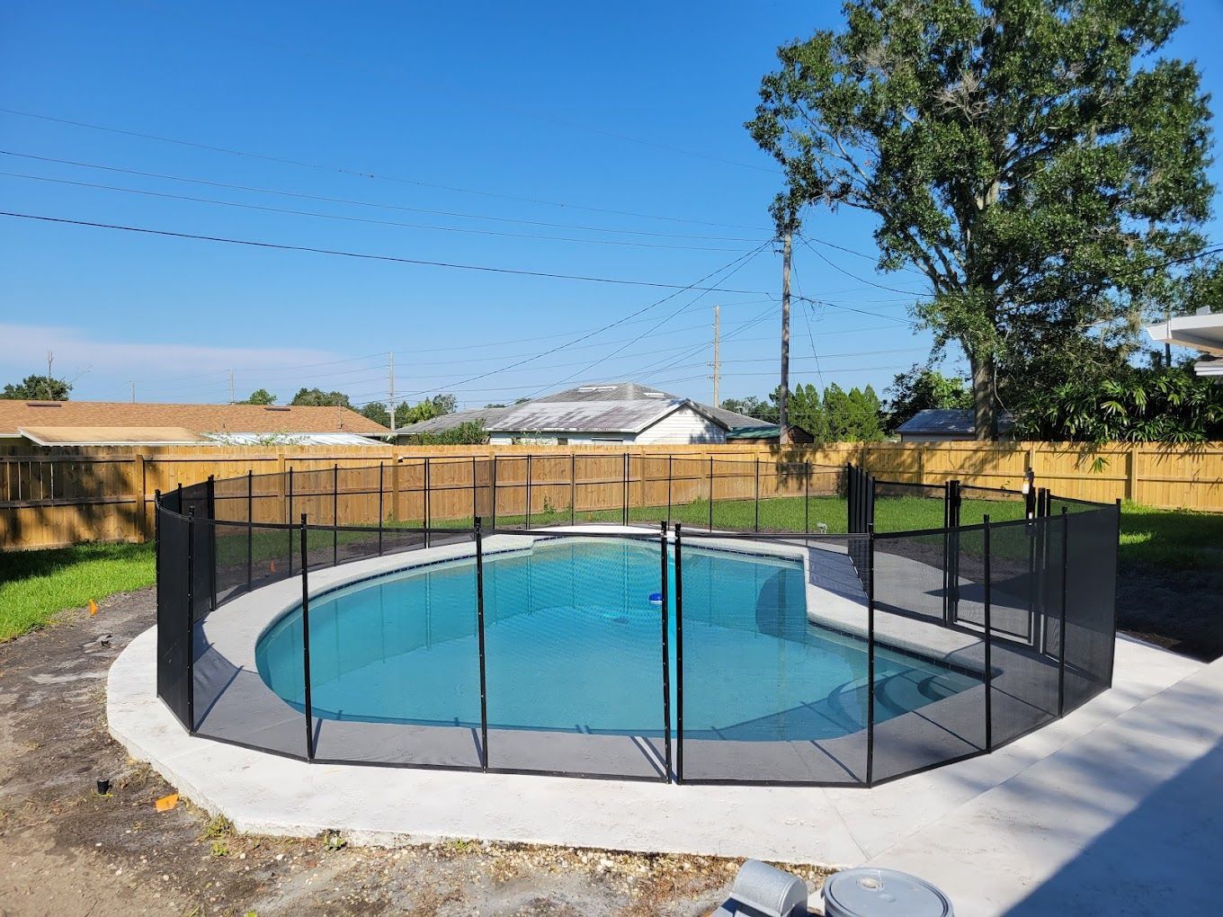 A large swimming pool with a fence around it