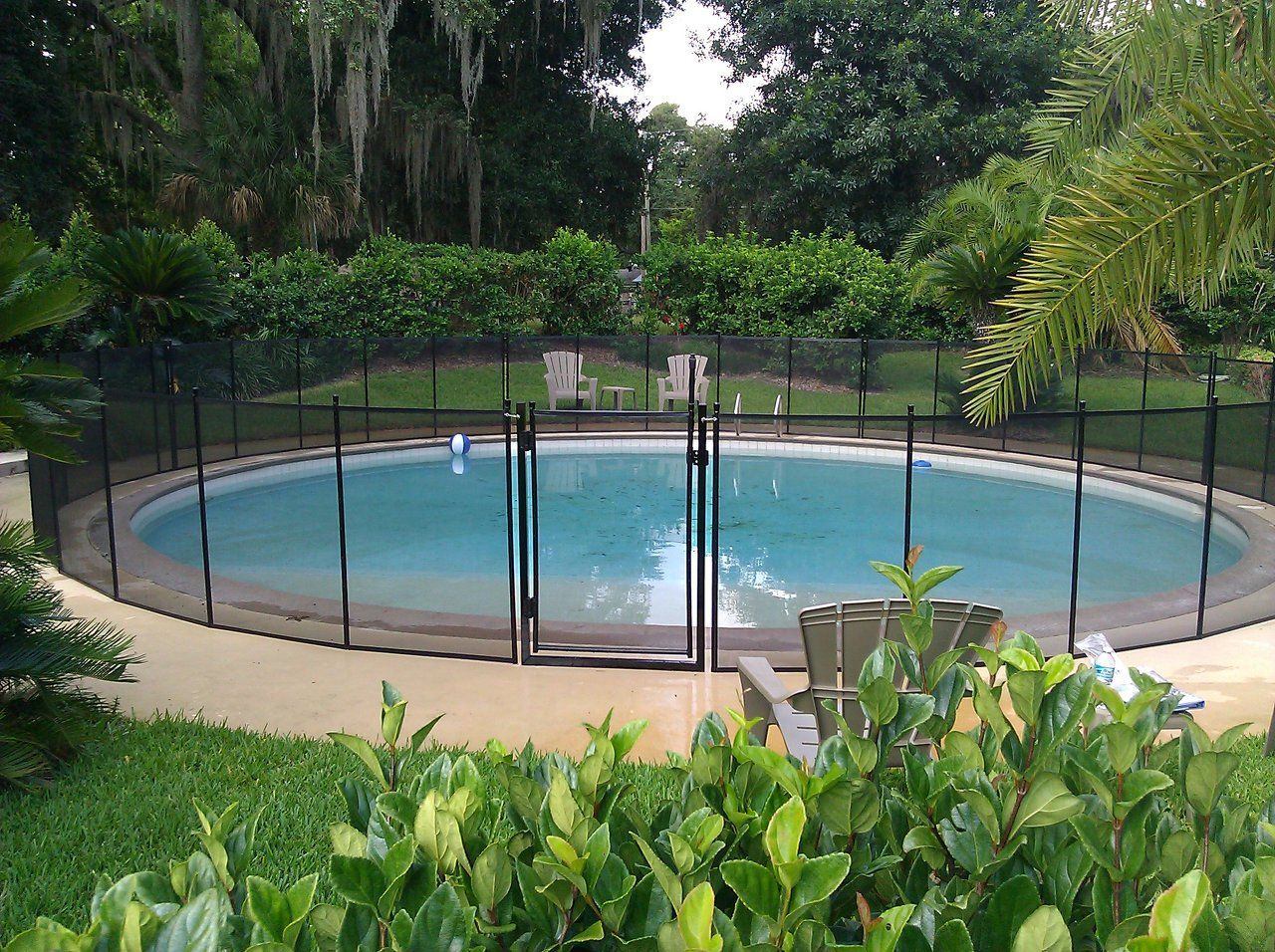 A large swimming pool with a fence around it and a gate.
