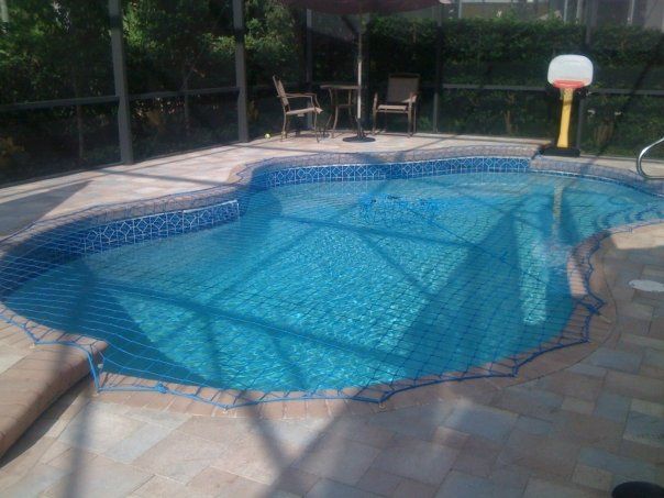 A large swimming pool with a basketball hoop in the background