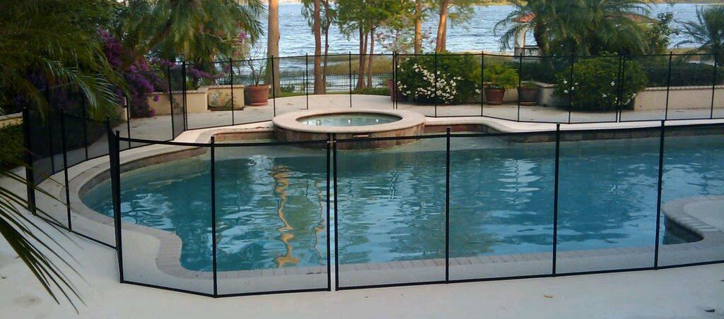 A large swimming pool with a fence around it.