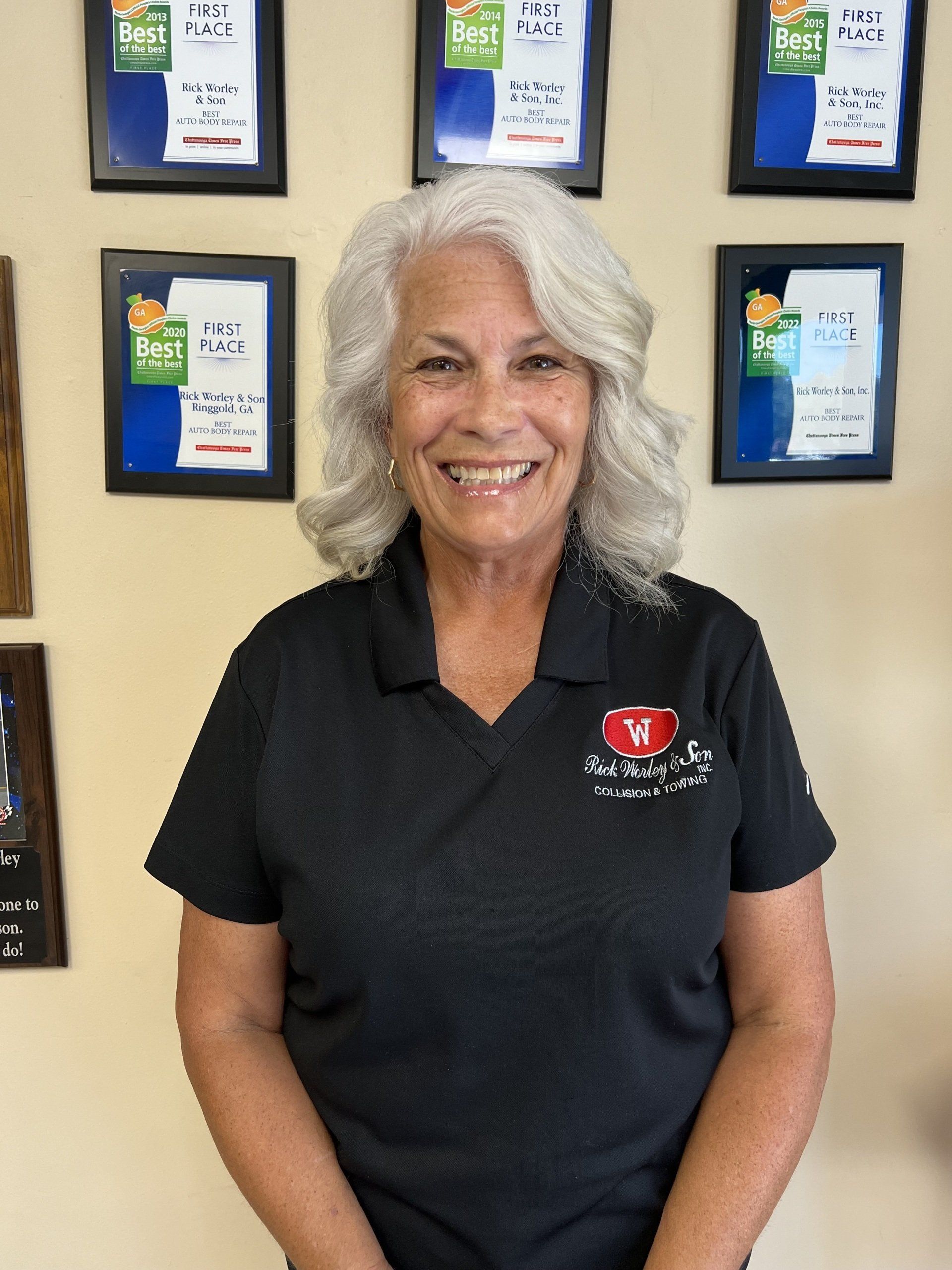 A woman wearing a black shirt with a red heart on it