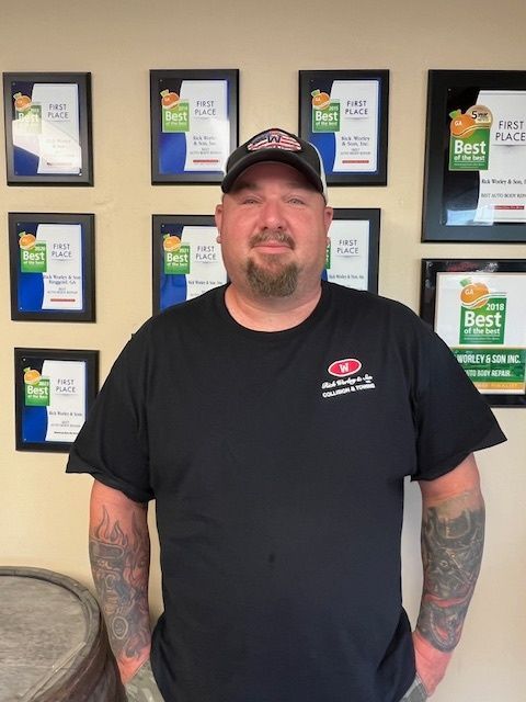 A man in a black shirt with the word best on it