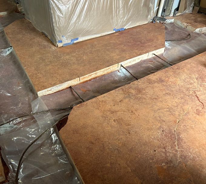 Brown insulation boards wrapped in plastic on a floor during construction or renovation