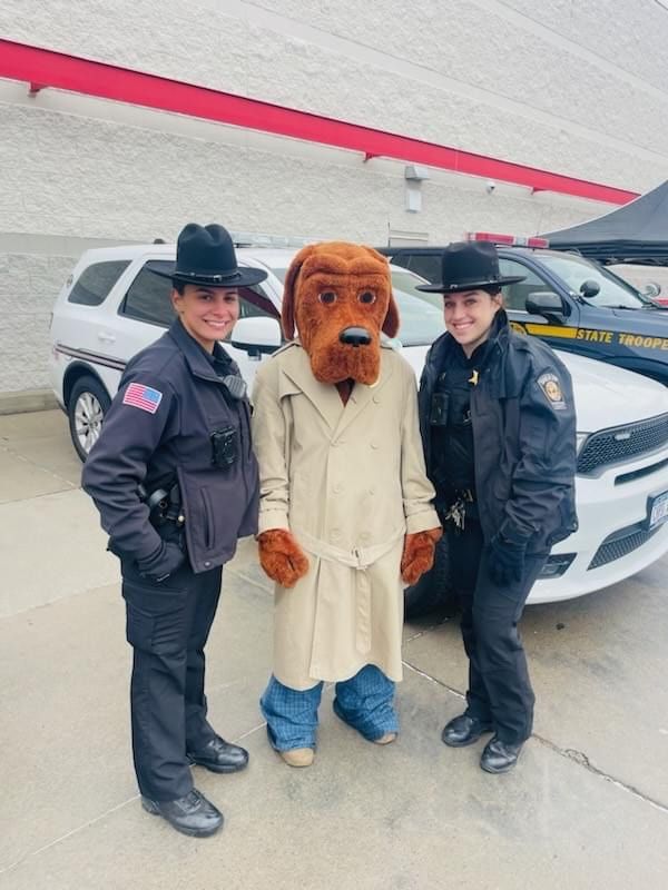 Two police officers and a mascot are posing for a picture