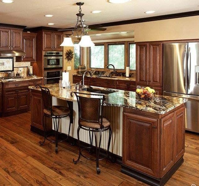Spacious kitchen with wood cabinetry, granite island, stainless appliances, and hardwood floors