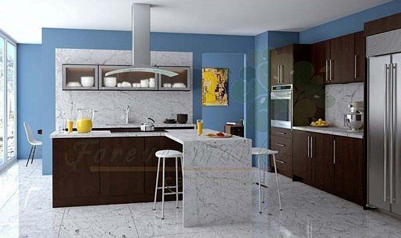 Modern kitchen with dark wood cabinets, white island, blue walls, and a large stainless-steel refrigerator
