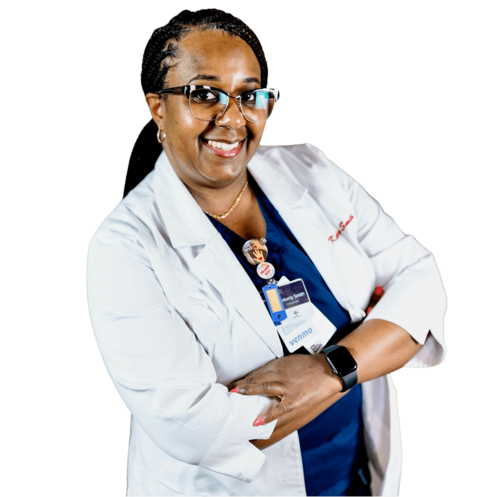 Woman in medical coat smiles, arms crossed, wearing glasses and a smartwatch.