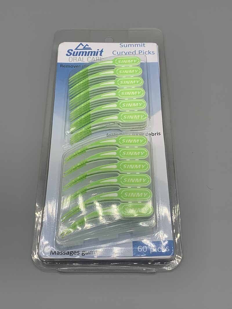 A package of green hair clips is sitting on a table.