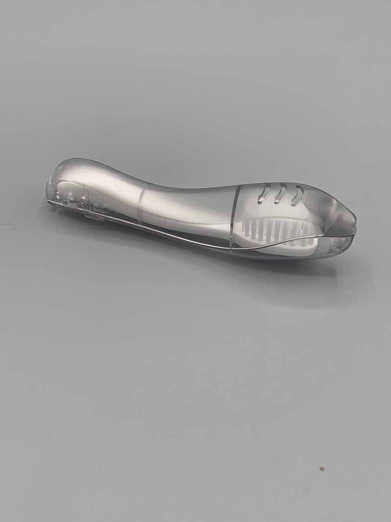 A silver object is sitting on a gray surface.