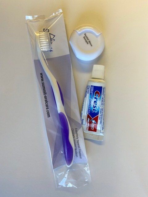 A toothbrush and a tube of crest toothpaste