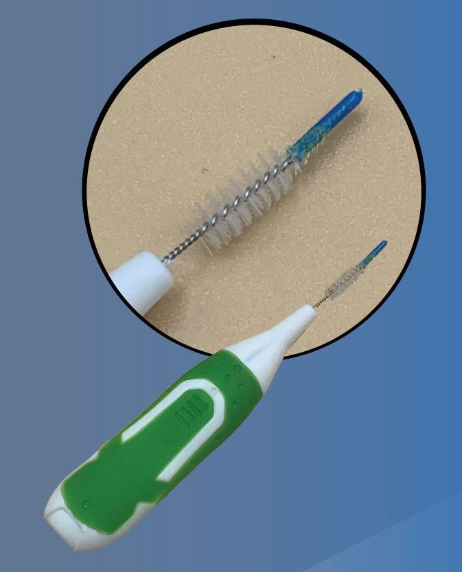 A green and white brush with the letter c on it