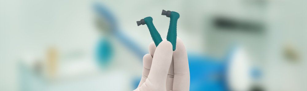 A person is holding a pair of dental brushes in their hand.