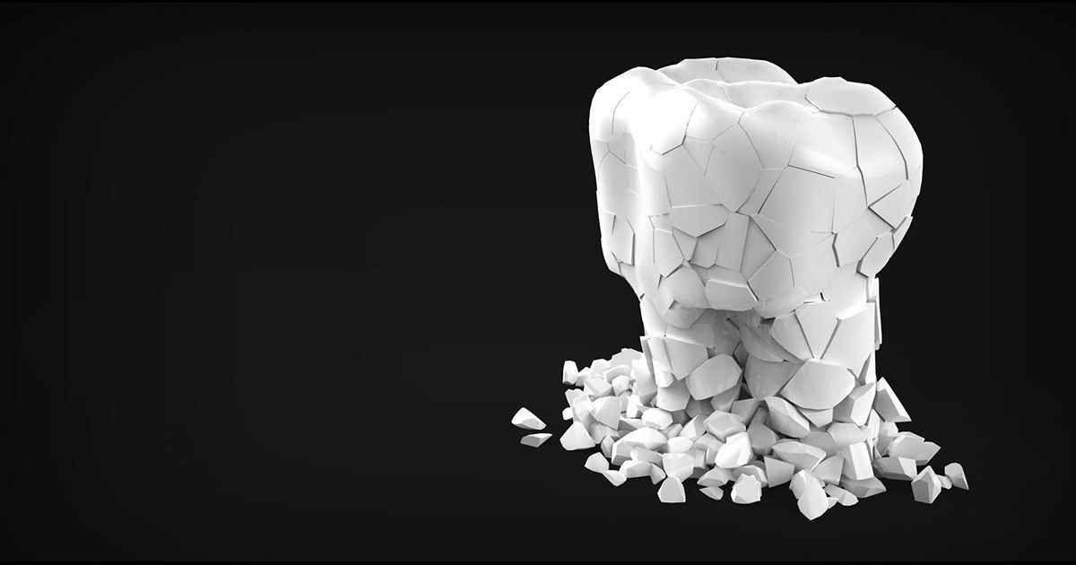 A tooth is breaking into pieces on a black background