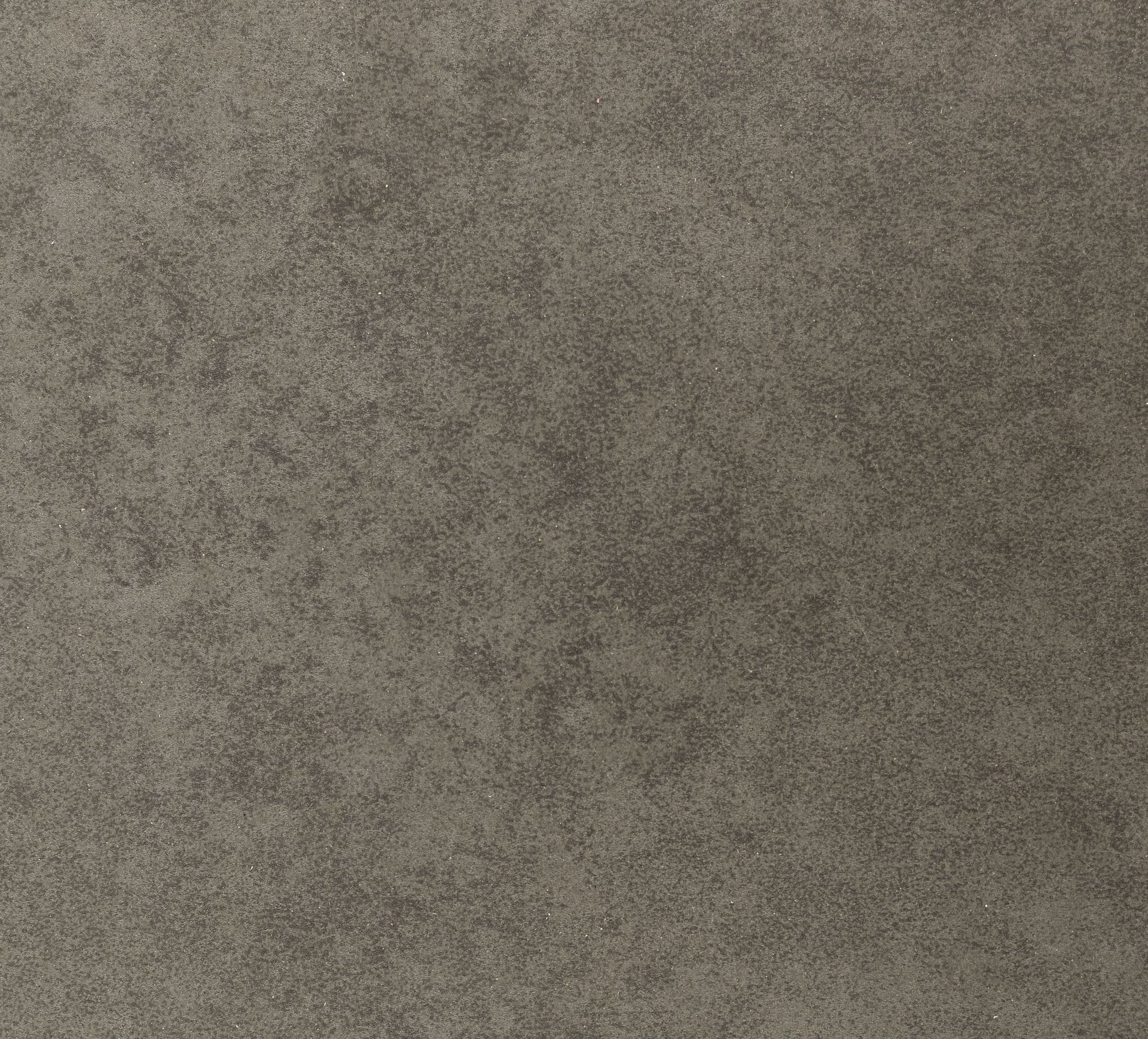 Textured, gray-brown surface, possibly fabric or stone, with a speckled appearance.