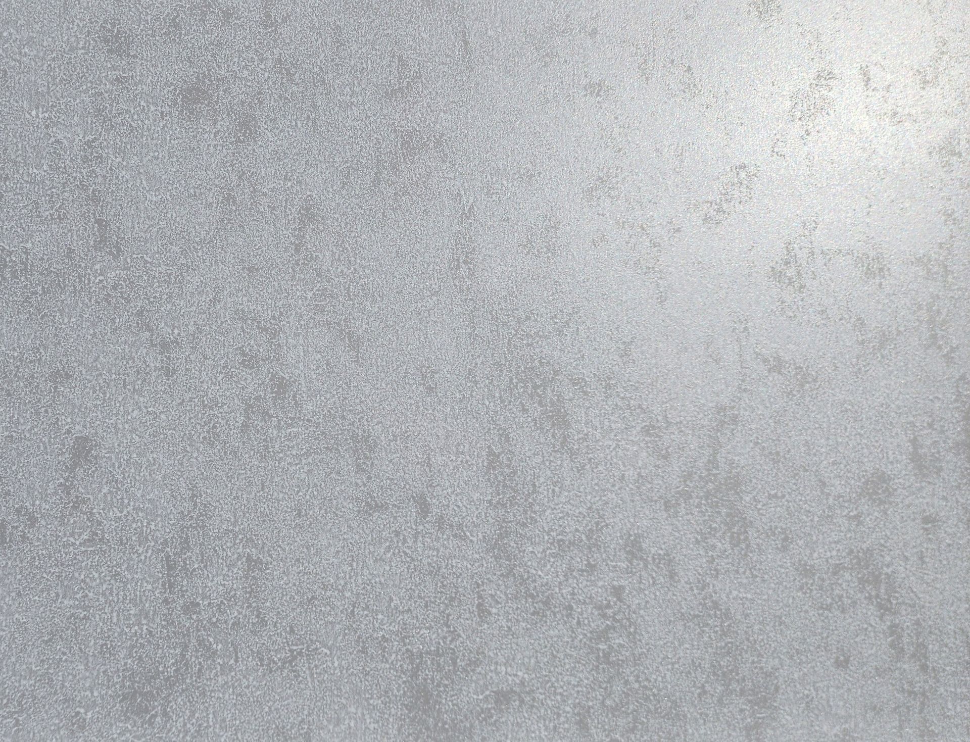 Textured gray surface with subtle highlights.
