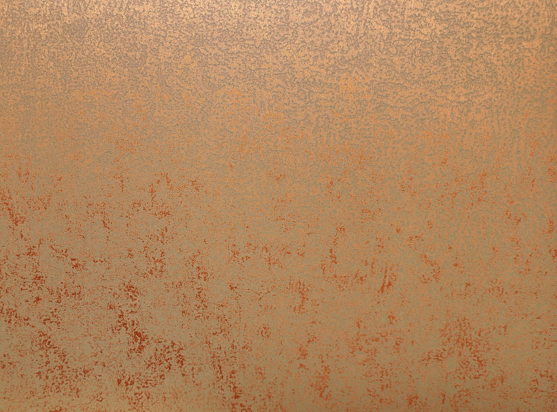 Copper-colored textured wall with a gradient of light to dark shades.