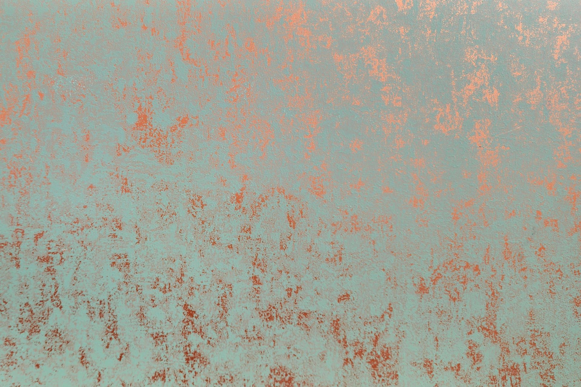 Textured surface with teal base and copper-colored speckling.