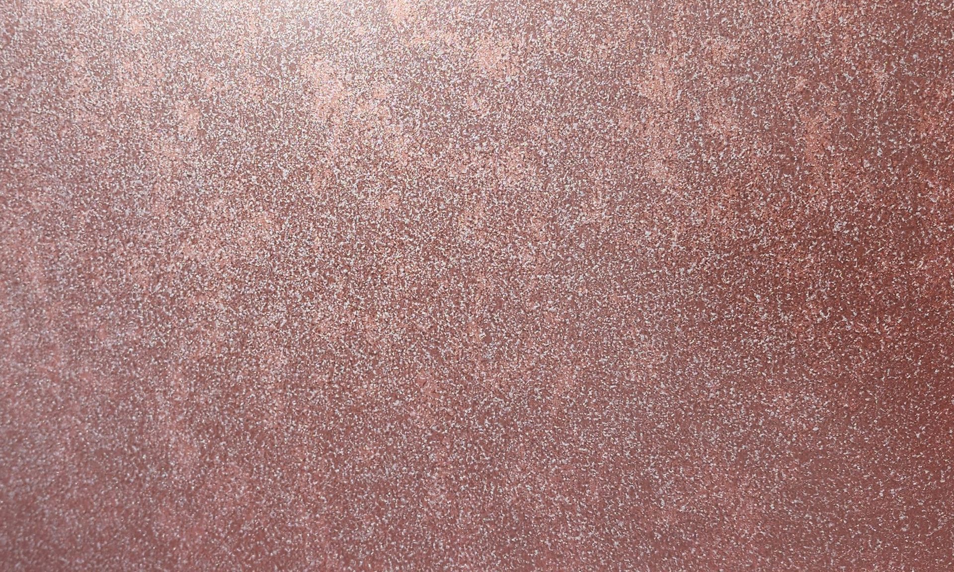 Close-up of a textured surface. The color is a shimmering reddish-brown.