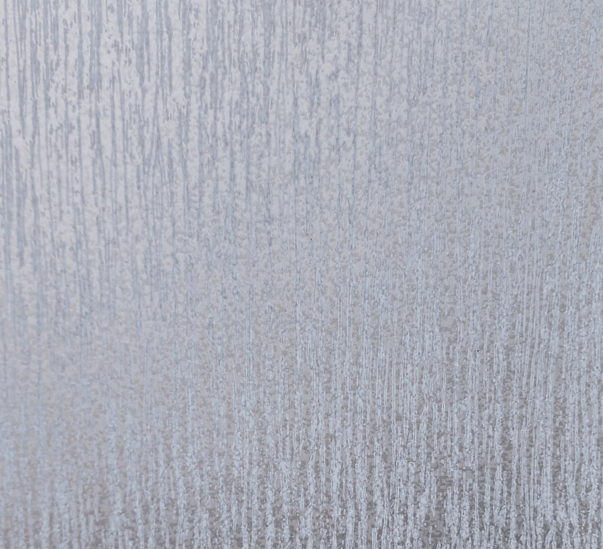 Textured silver surface with vertical streaks.