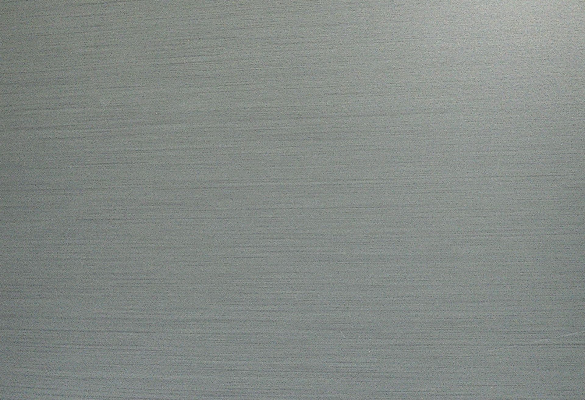 Textured, gray surface with horizontal striations.