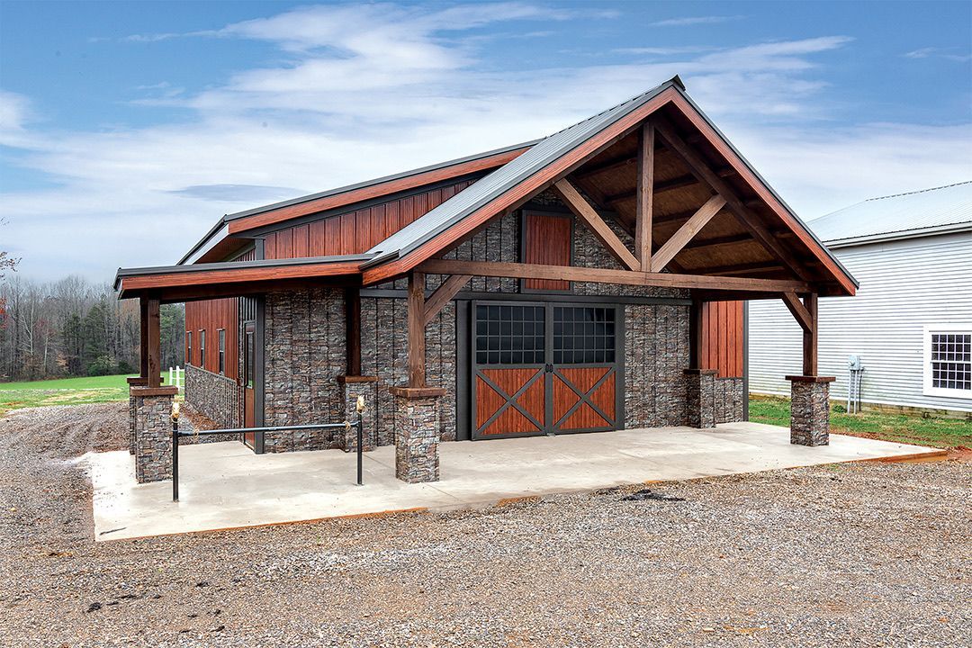 Stone and wood building with a covered porch. Brown wooden door, stone columns. Outdoors.