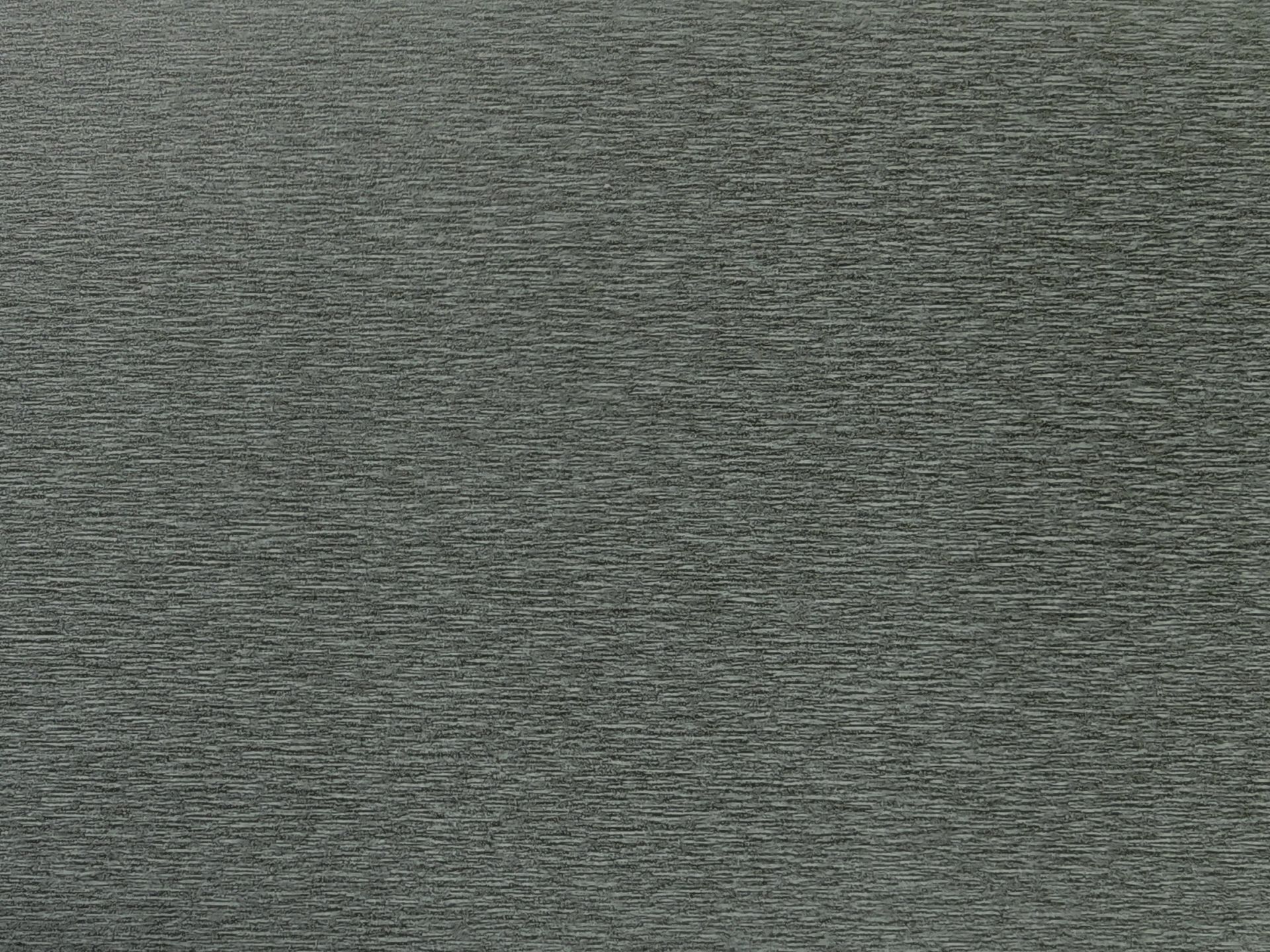 Gray textured surface, appearing like dense woven fabric or stone.