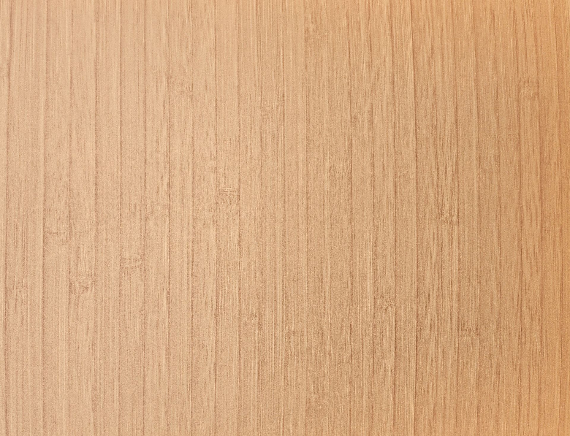 Close-up of a light brown, textured surface with vertical lines, likely wood grain.